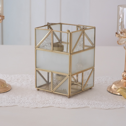 Gold glass lantern adding warm ambience to living room and bedroom décor.