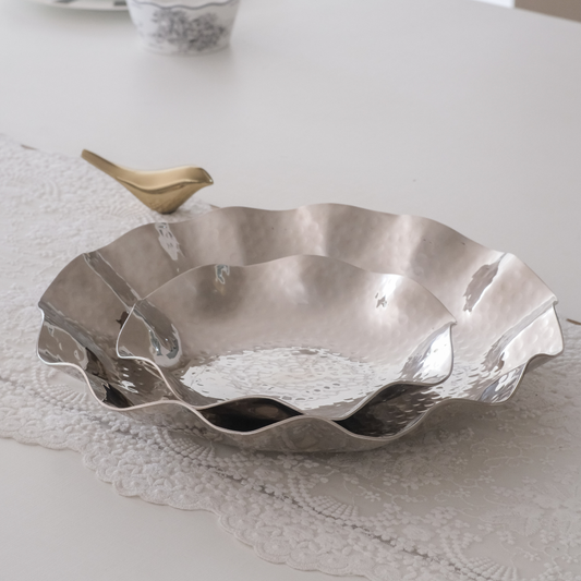Set of 2 hammered scalloped stainless steel silver serving trays in 8 inch and 13 inch sizes.