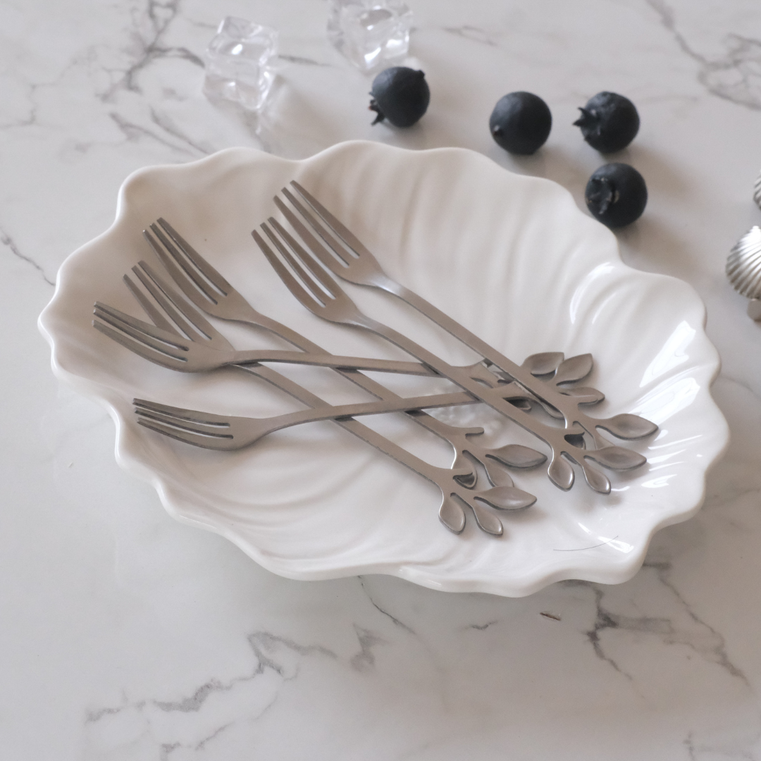 Luxury stainless steel fruit fork set with leaf-shaped handles for stylish table settings.