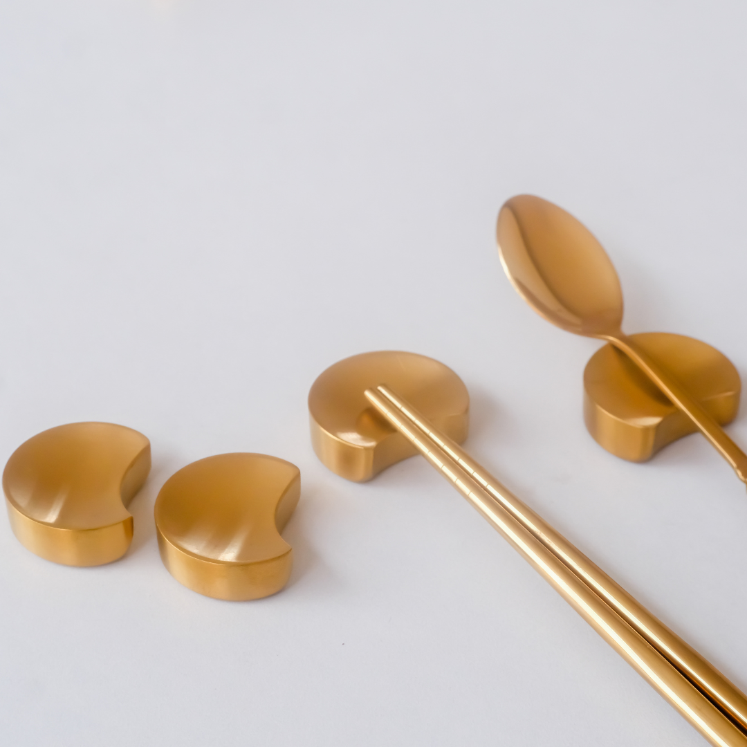 Set of gold kitchen utensils - chopstick holder and spoon rest for luxury dining setup and decor