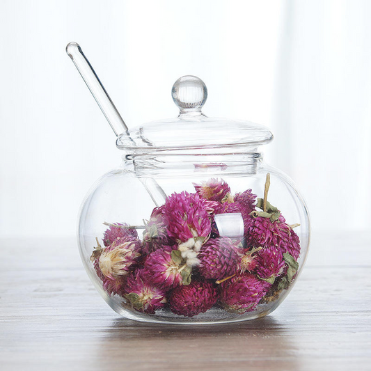 White background shot – glass ghee container with lid and spoon