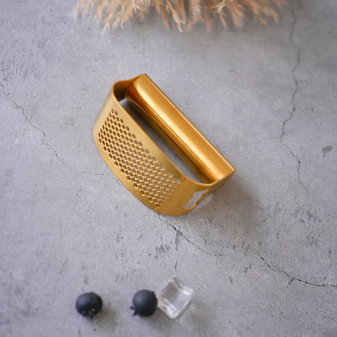 Stainless steel garlic press and masher in gold and silver finish