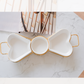 Heart shaped ceramic snack platter with gold metal stand for serving snacks and dips.