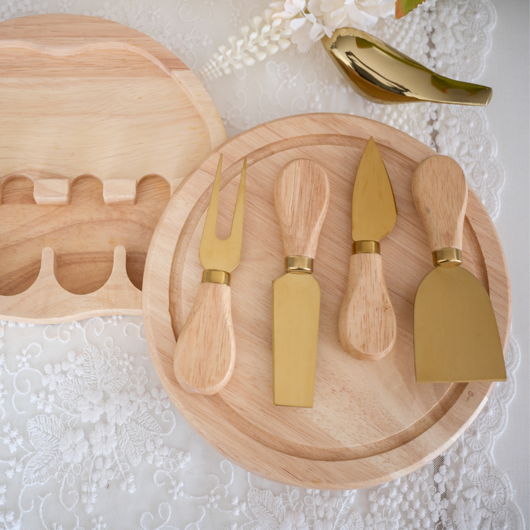 Premium cheese board with rotating storage compartment and gold cutlery.