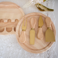 Premium cheese board with rotating storage compartment and gold cutlery.