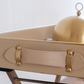 Luxury beige butler tray styled with embossed ceramic tea set and serving cloche for sophisticated entertaining.
