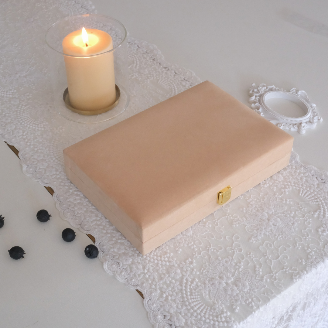 A luxury finish giftbox placed on white runner with hurricane