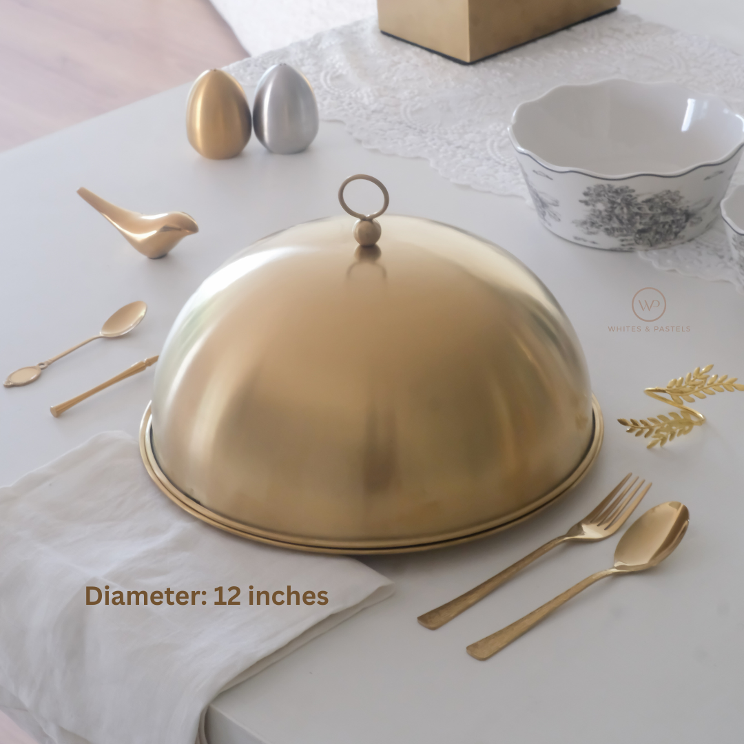 Gold platter with cutlery on a white tablecloth