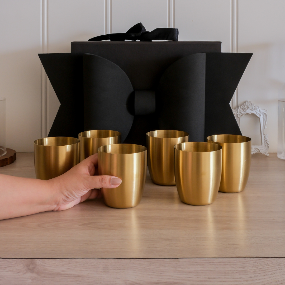 A women holding a big size gold glass