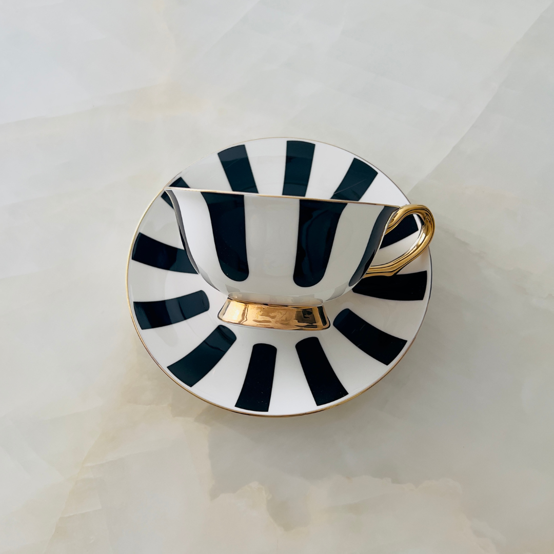 Stylish porcelain tea cups with gold accents and floral gift box for luxury tea experiences.