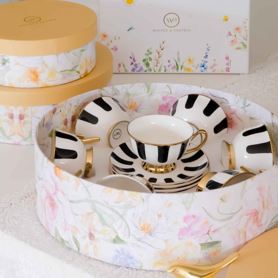 Stylish porcelain tea cup and saucer set featuring bold black stripes and gold detailing.