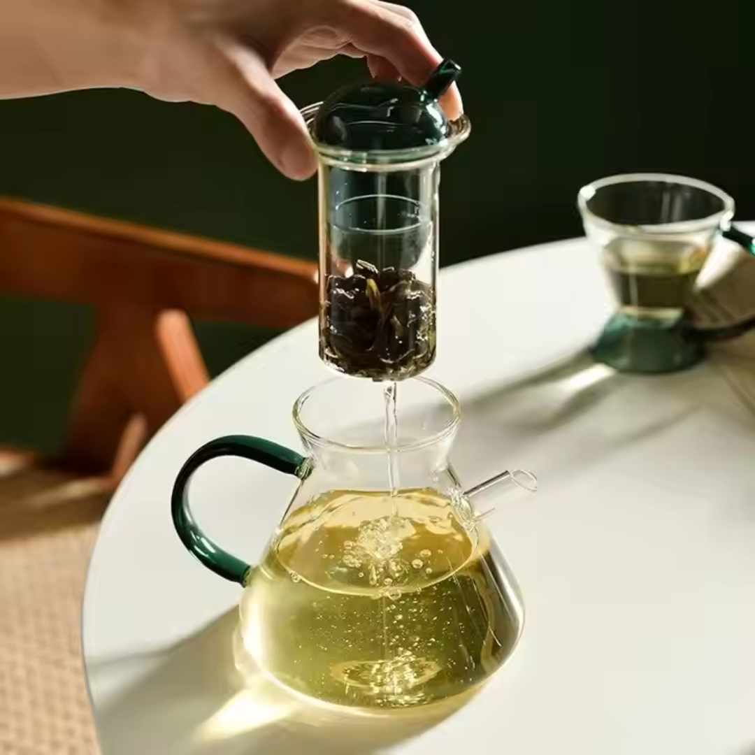 Green glass teapot with built-in filter and luxury tea cups