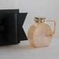 Brown glass jug with gold lid and elegant handle displayed with a luxury black gift box