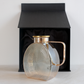 Brown glass serving jug with gold lid and sleek handle for stylish water and beverage serving in Black Gift Box