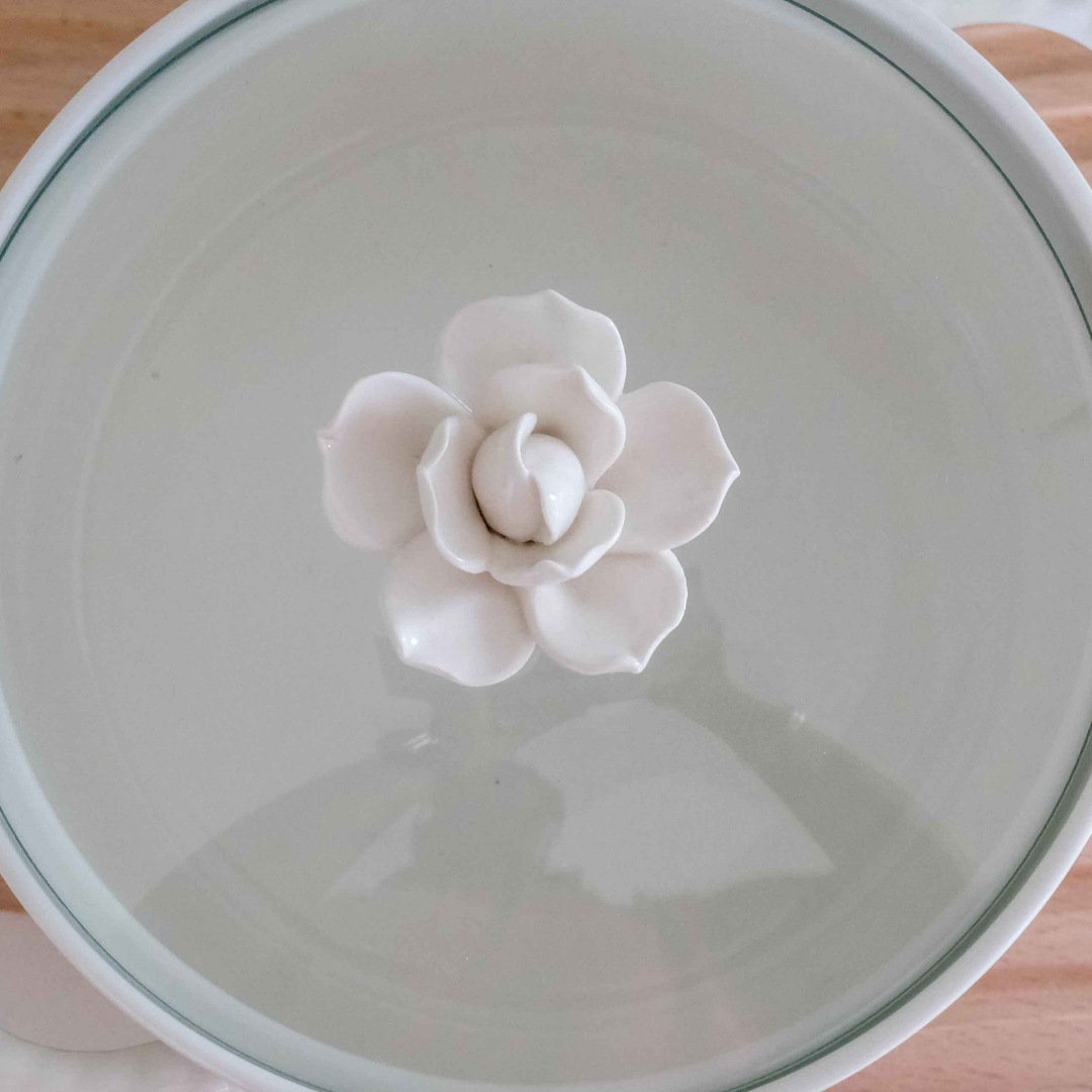 White ceramic serving pot with glass lid that is microwave and dishwasher safe