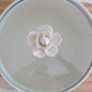 White ceramic serving pot with glass lid that is microwave and dishwasher safe