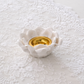 Close-up of glazed ceramic lotus tea light holder with gold center
