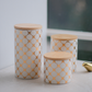 Set of 3 white ceramic snack storage jars with wooden lids