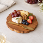 Cheese, fruits and some dry fruits placed in our cute little solid wood charcuterie board 