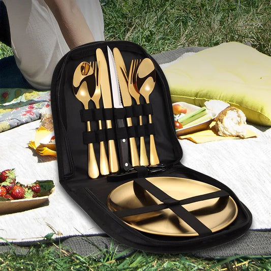 A cutlery set for two people displayed in a carry bag, with the set including knives, forks, and spoons, placed on a picnic setting.