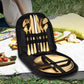 A cutlery set for two people displayed in a carry bag, with the set including knives, forks, and spoons, placed on a picnic setting.