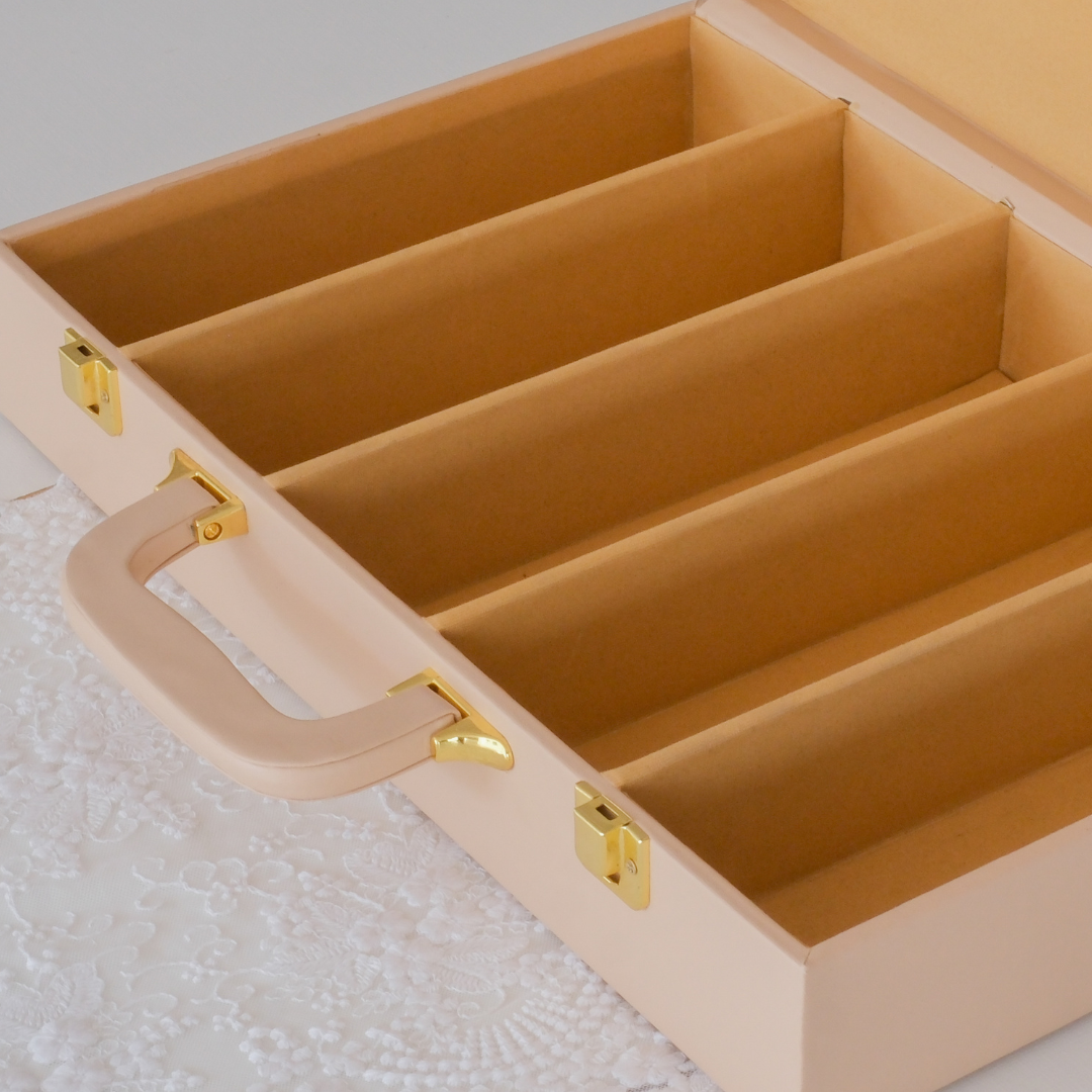  Stainless steel cutlery stored in a soft-lined beige organiser box