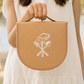 A women holding our cutlery set in a compact bag