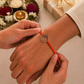 Sister tying Silver Raakhi