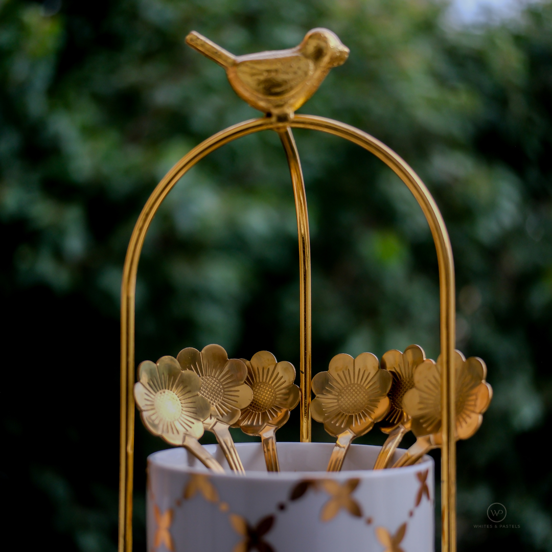 Floral handle dessert spoon with gold finish in cutlery holder
