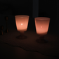 Glowing with a warm pink-orange light in a dark setting
