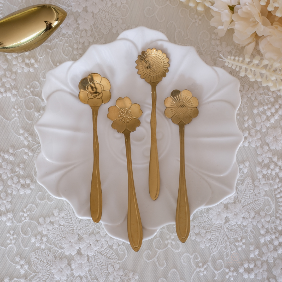 Modern gold flatware featuring detailed carved flower designs for elegant dining and gifting.