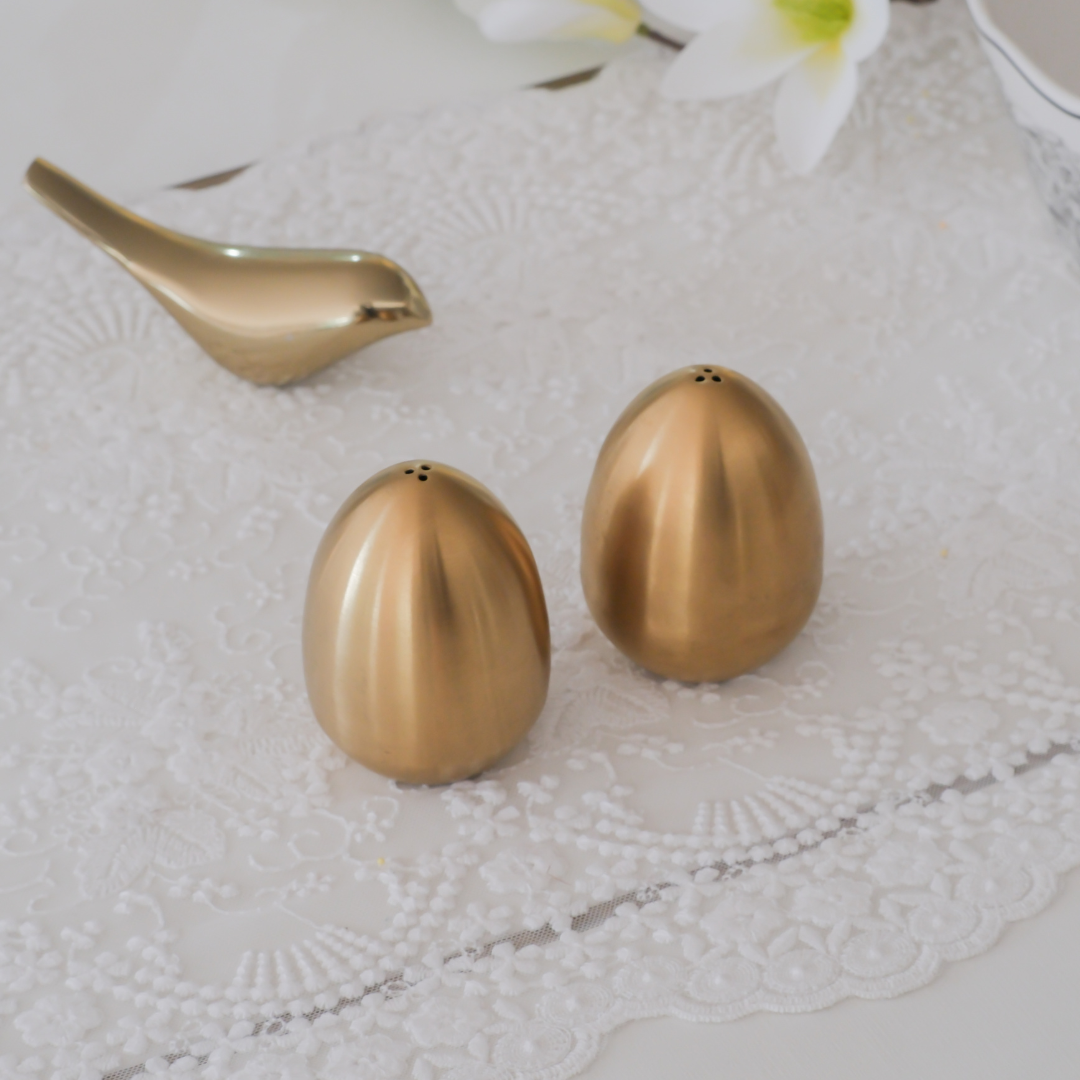 Modern kitchen table salt and pepper shakers in sculptural egg design.