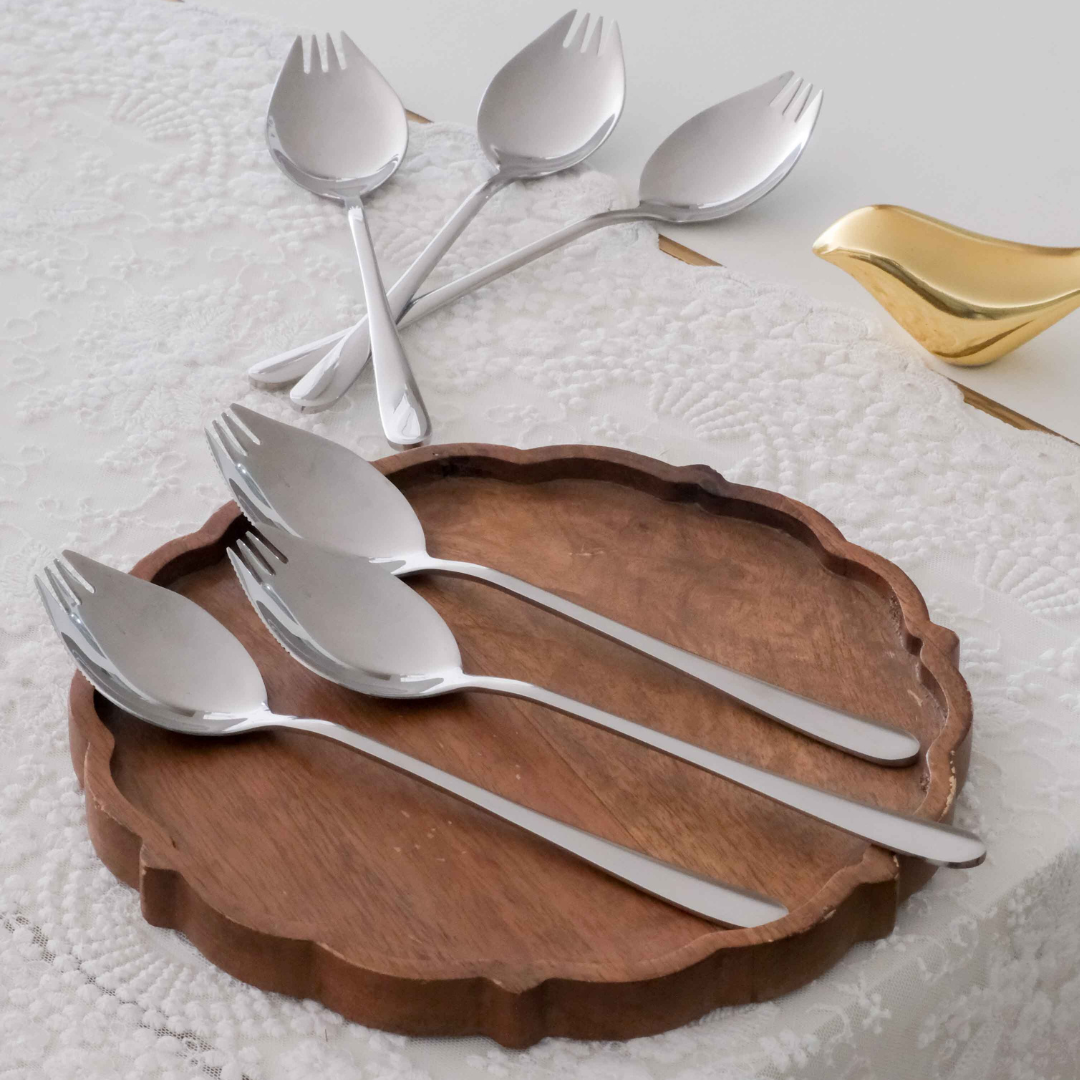 Premium gold spoon fork collection displayed on a rustic wooden platter.