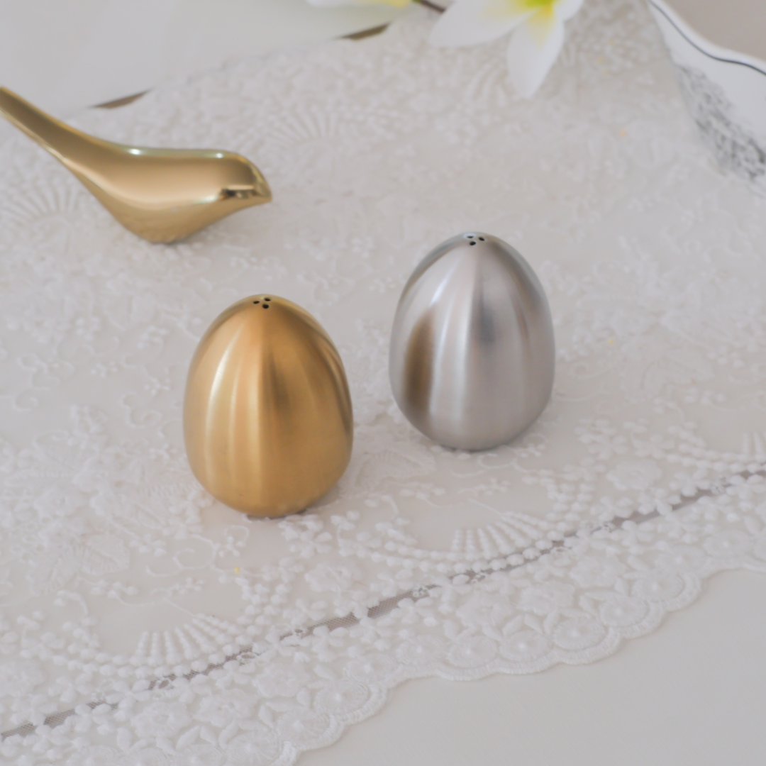 Contemporary metallic salt and pepper shakers for luxury dining table décor.