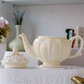 High-quality porcelain tea pot with Victorian embossed craftsmanship and graceful curved spout.
