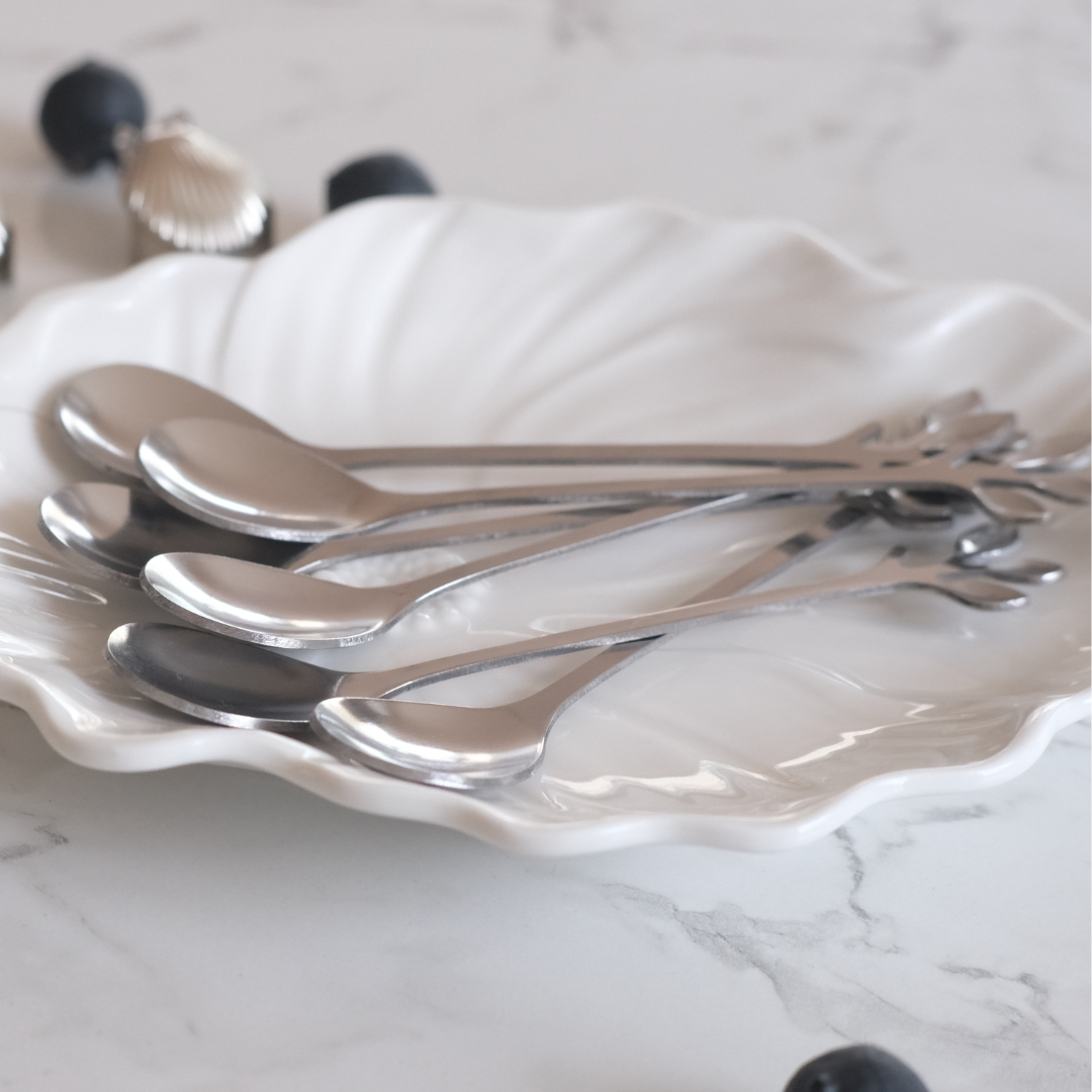 Elegant silver tea spoon set with decorative leaf handles for tea, coffee and elegant entertaining.
