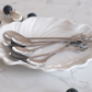 Elegant silver tea spoon set with decorative leaf handles for tea, coffee and elegant entertaining.