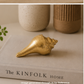 Handcrafted brass home decor accent styled with candle and indoor plants