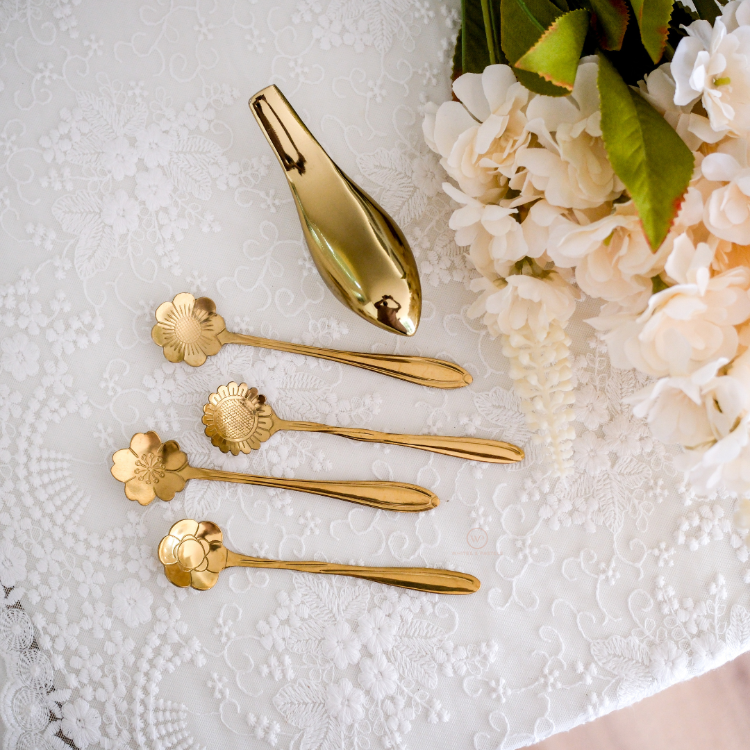 Luxury gold dessert spoons with beautifully carved floral bowl designs and elegant long handles.