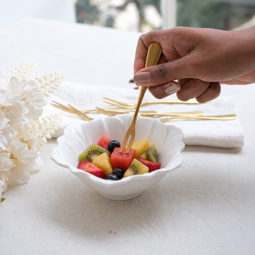 Gold-fruit-serving-fork-with-fresh-fruits in lotus bowl