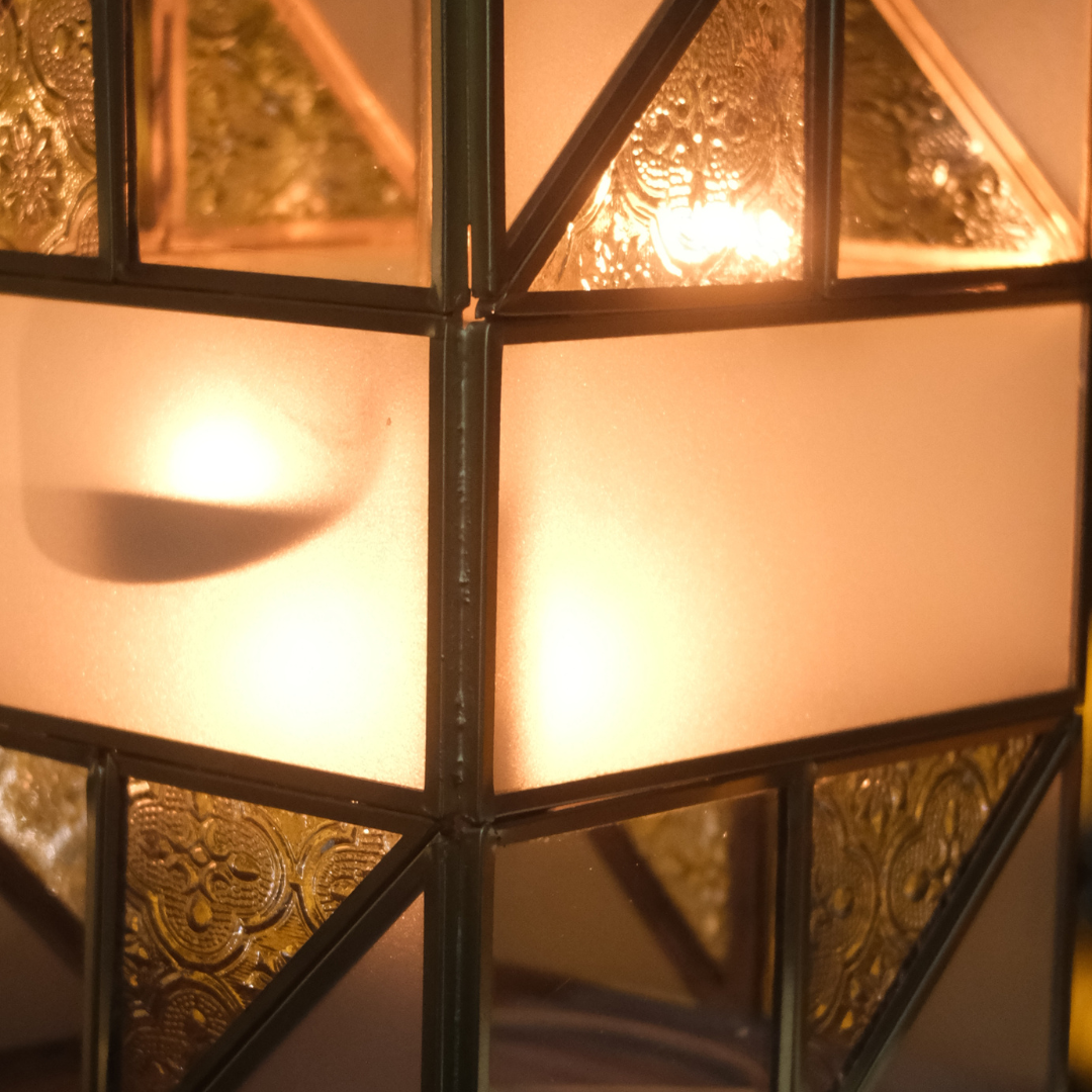 Contemporary geometric glass tealight candle holder with gold frame for living room and dining table décor.