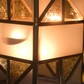 Contemporary geometric glass tealight candle holder with gold frame for living room and dining table décor.