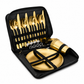 Gold cutlery set with plates and cups in a black carrying case on a white background