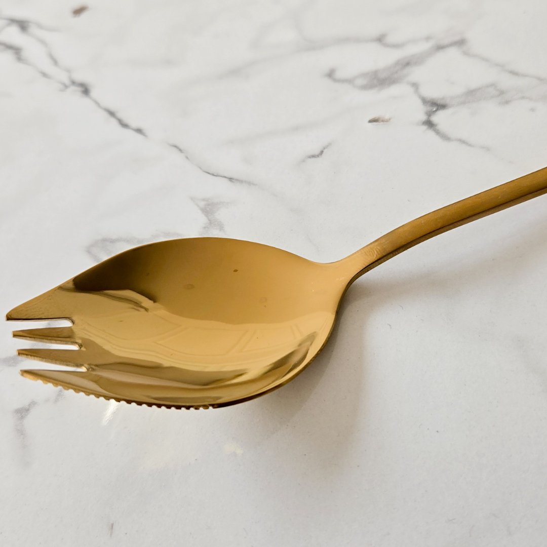 Minimalist gold spork combining the convenience of a spoon and fork in one elegant design.