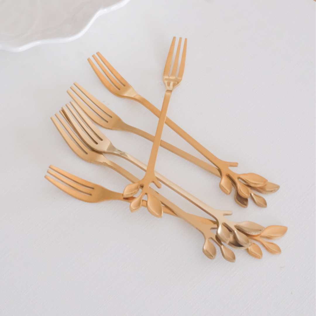 Stainless steel fruit forks featuring artistic gold leaf handle design for cheese