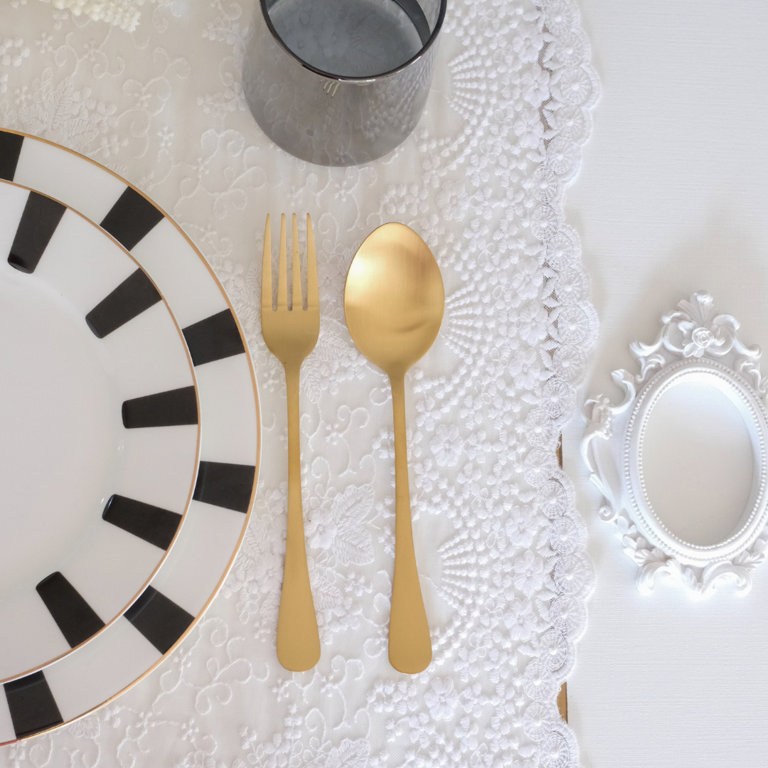 Gold Matte Spoon and Fork placed over white runner with dining setup