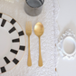 Gold Matte Spoon and Fork placed over white runner with dining setup