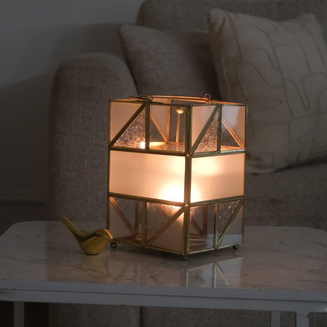 Gold metal and glass votive holder for tea lights and decorative candles.