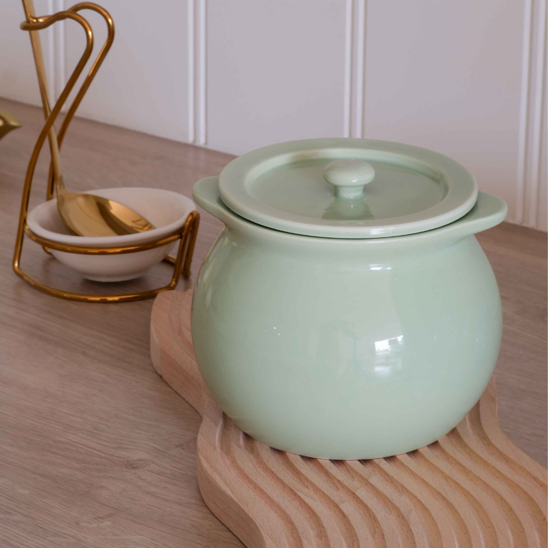 Green ceramic ghee pot for stylish and organised kitchen storage.