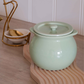 Green ceramic ghee pot for stylish and organised kitchen storage.